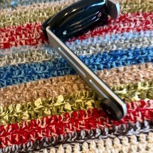 Black and Silver camera grip and universal remote